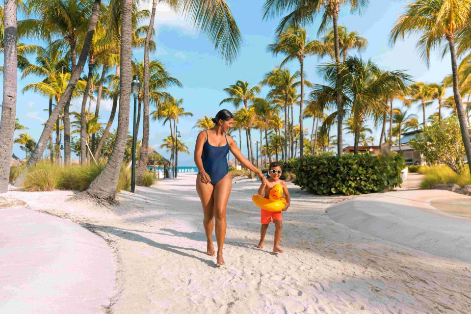 Mom Son Walking On The Beach